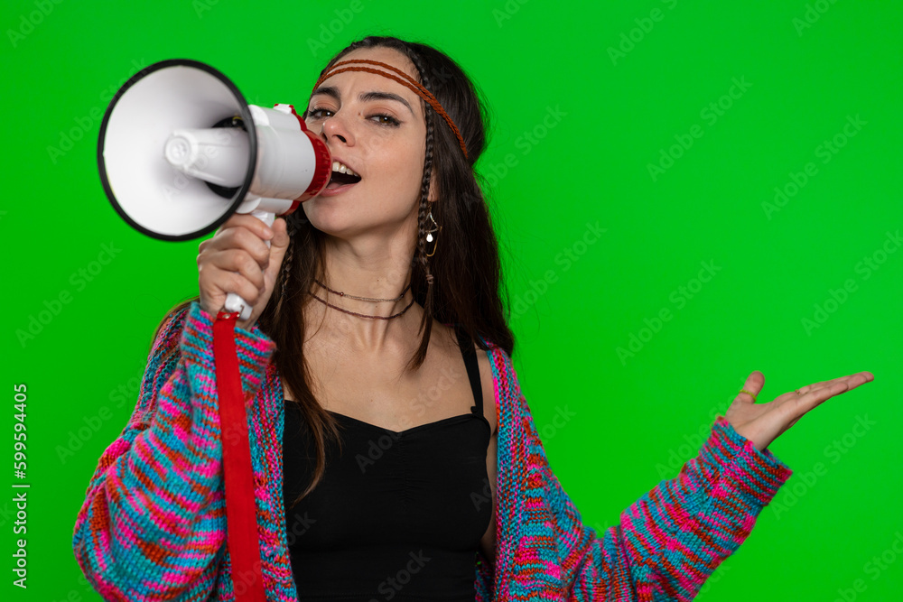 Woman talking with megaphone, proclaiming news, loudly announcing advertisement, warning using loudspeaker to shout speech, pointing empty place. Copy-space. Pretty girl on green chroma key background Woman talking with megaphone, proclaiming news, loudly announcing advertisement, warning using loudspeaker to shout speech, pointing empty place. Copy-space. Pretty girl on green chroma key background