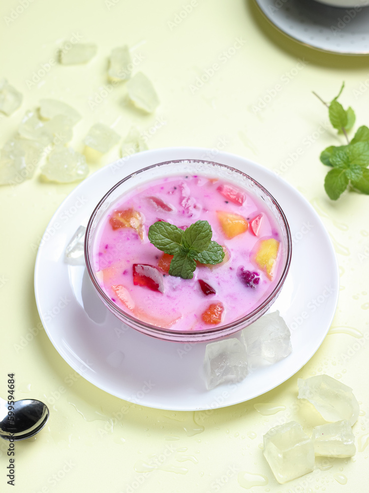 sop buah or fruit soup is indonesian fruit cocktail ice made from various diced fruits mixed with ice cubes, condensed milk and red syrup. popular food for breakfasting sop buah or fruit soup is indonesian fruit cocktail ice made from various diced fruits mixed with ice cubes, condensed milk and red syrup. popular food for breakfasting