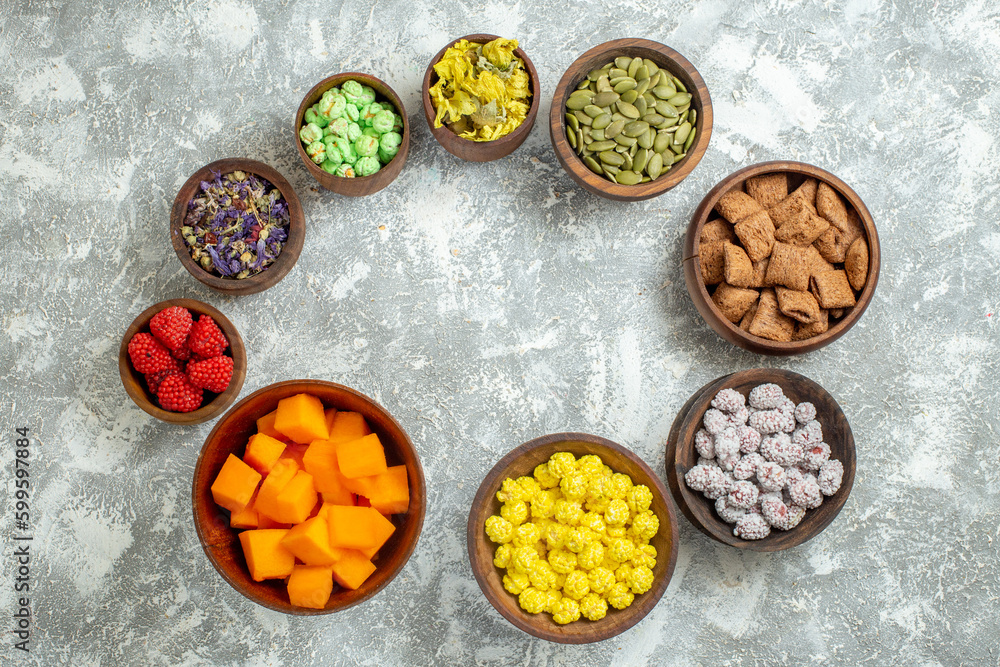 top view different candies with flowers on white background color candy sugar tea flower top view different candies with flowers on white background color candy sugar tea flower