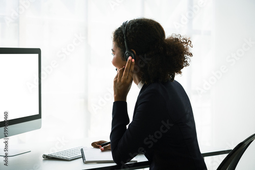 African american woman wearing headset with microphone and talking support customer in call center
