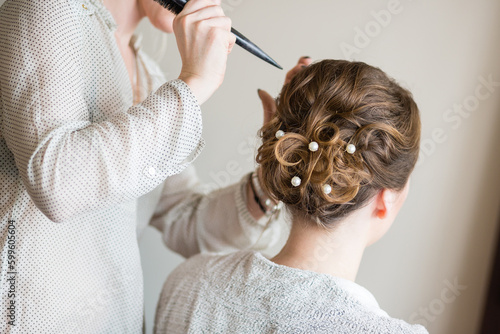 Bride getting her hair done before wedding