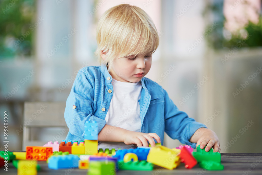 Little boy playing with colorful plastic construction blocks Little boy playing with colorful plastic construction blocks