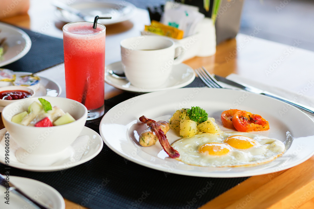 Fried eggs, fruit salad and fresh watermelon juice Fried eggs, fruit salad and fresh watermelon juice
