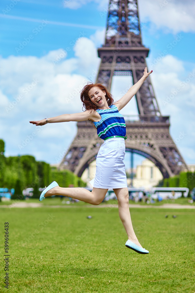 Girl jumping near the Eiffel Tower in Paris
