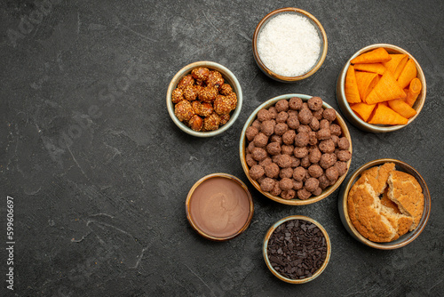 top view sweet nuts with cocoa flakes and cips on dark background snack milk meal breakfast color