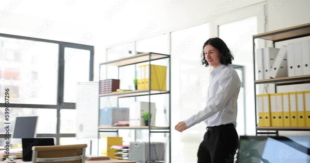 Employee celebrating successful completion of negotiation and closing deal. Student trainee dancing in office raised his hands and feels happy Employee celebrating successful completion of negotiation and closing deal. Student trainee dancing in office raised his hands and feels happy