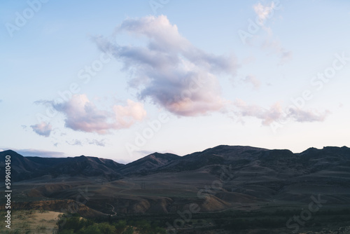Cloudy blue sky over mountainous terrain during daytime