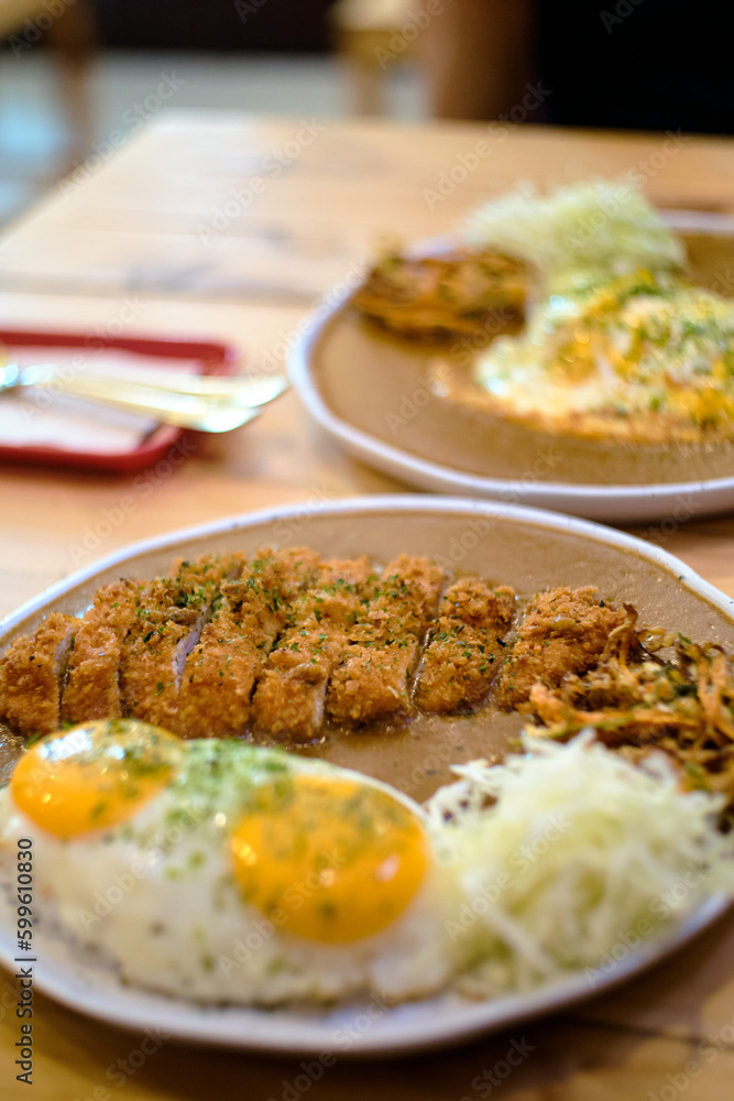 Double Delight: Two Hearty Bowls of Japanese Curry Rice Served in a Cozy Cafe