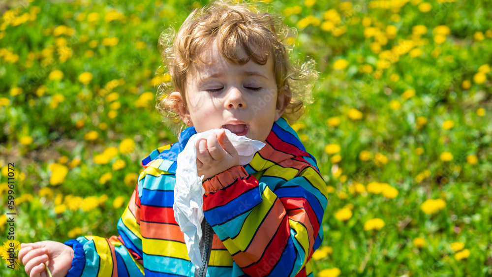 The child is allergic to flowers. Selective focus. The child is allergic to flowers. Selective focus.