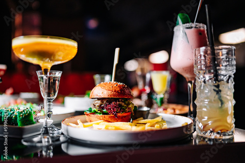 burger with meat, vegetables and cheese on table