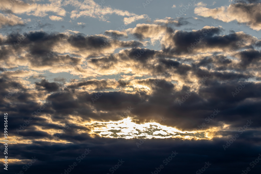 Sky replacement sun rays peeking through dark dramatic orange and gray clouds Sky replacement sun rays peeking through dark dramatic orange and gray clouds