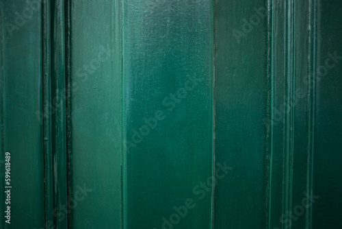 Full frame flat close up of wooden structure from green door. Gradient green colors in warm tone woith veertical lines. photo