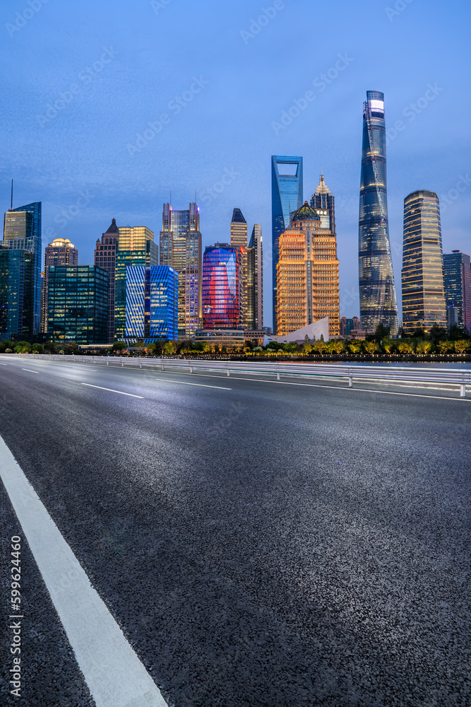 Asphalt road and city skyline with modern buildings in Shanghai at night, China. Asphalt road and city skyline with modern buildings in Shanghai at night, China.