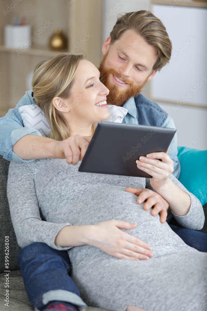 pretty woman and man using a tablet together