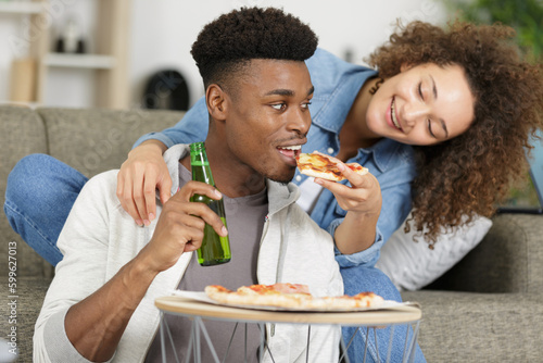 happy young couple with pizza and beer