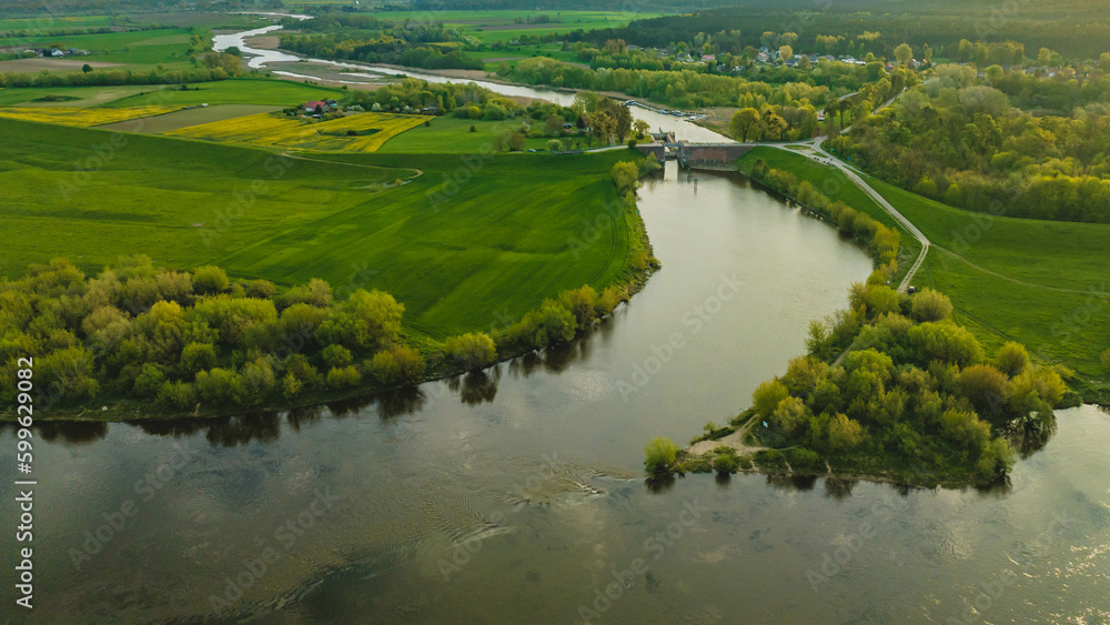 Floodgate in Biała Góra. Where the Nogat River flows from the Vistula. View from the drone, morning, spring. Poland. Floodgate in Biała Góra. Where the Nogat River flows from the Vistula. View from the drone, morning, spring. Poland.