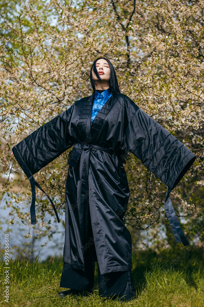 Young asian woman with long hair wearing black kimono Young asian woman with long hair wearing black kimono