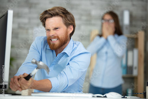 Quadro em tela angry and crazy man wants to damage notebook with hammer