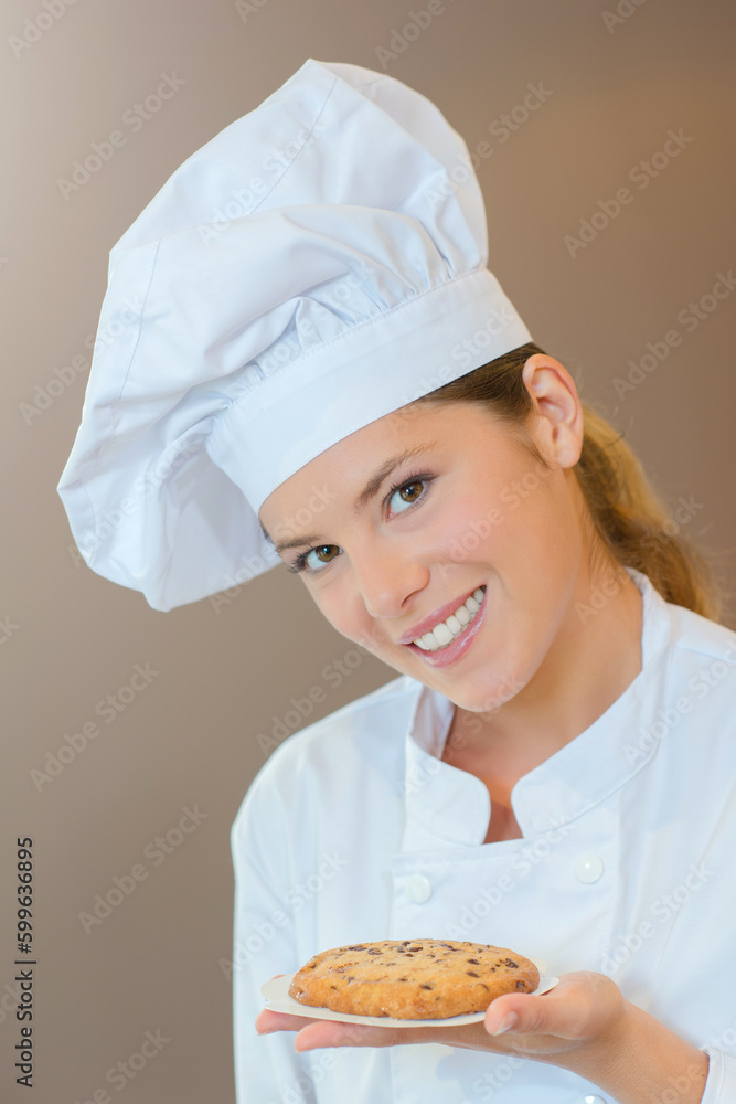 Holding a cookie she's just made Holding a cookie she's just made