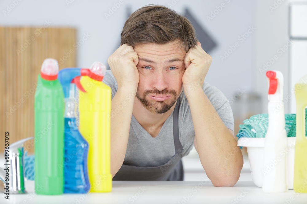 domestic service man or tired husband doing housework - obrazy, fototapety, plakaty 