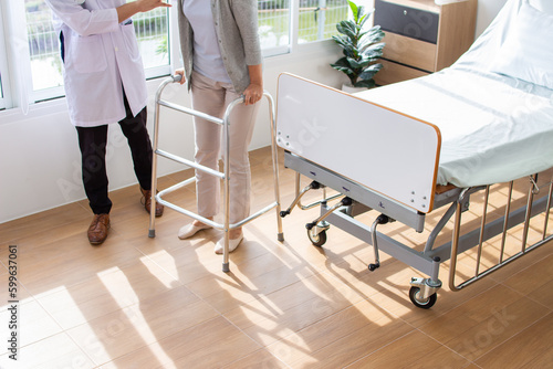 caucasian man doctor is examining the female older patient in wheelchair the hospital.