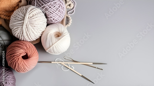 Crochet and knitting hobby. Colorful balls of yarn, knitting needles on table, with copy space, flat lay, and wood background.