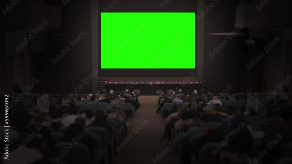 Crowd of people watch big green screen Stock Video Adobe Stock