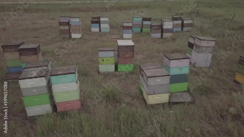 drone footage past bee hives in north dakota pasture with green grass