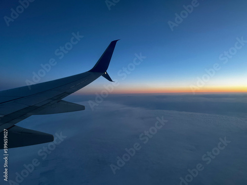 Flying above the clouds at sunset.