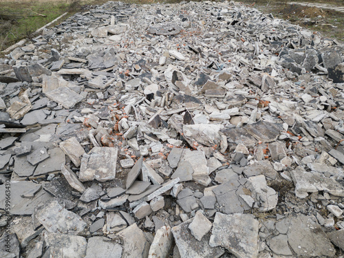 Aftermath after war debris rubble demolition ruin ruined field area concrete building part pile heap stack junk yard landfill