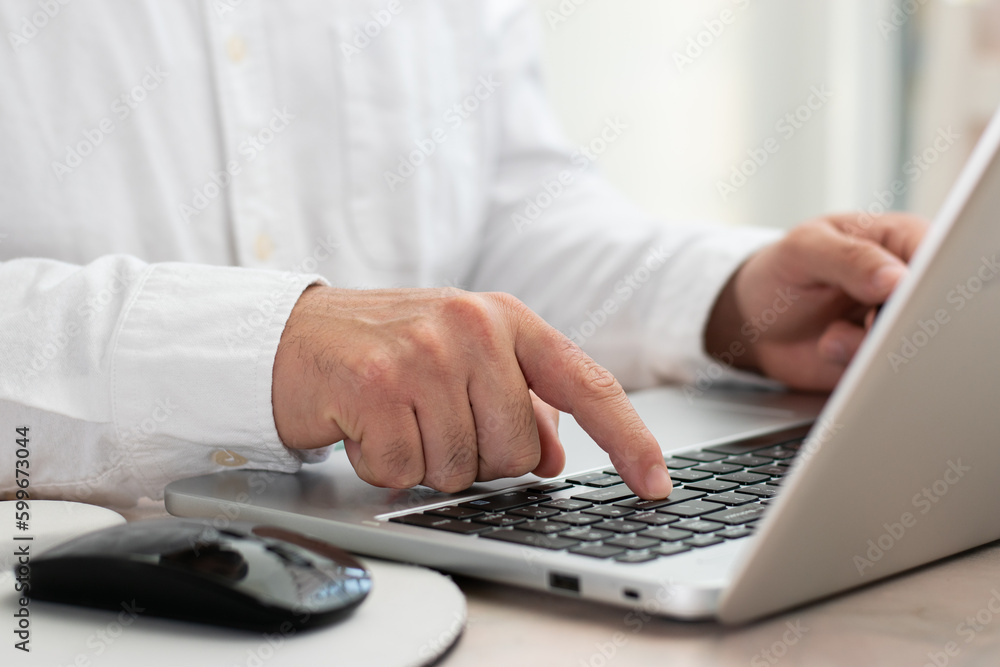 Close up of executive hand pushing Enter in the keyboard of their laptop Close up of executive hand pushing Enter in the keyboard of their laptop