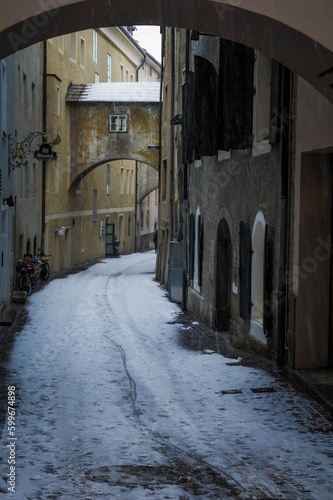 narrow road in bruneck during a snowfall