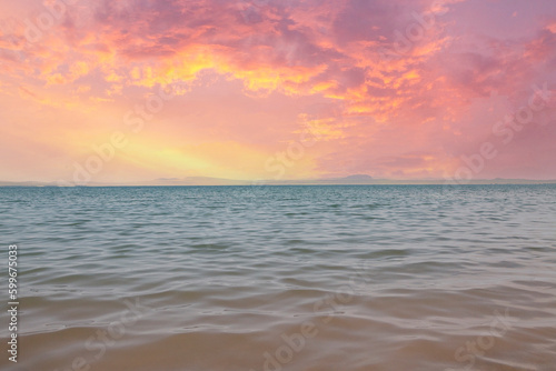 Water surface, sky and horizon line at sunset. With copy space.