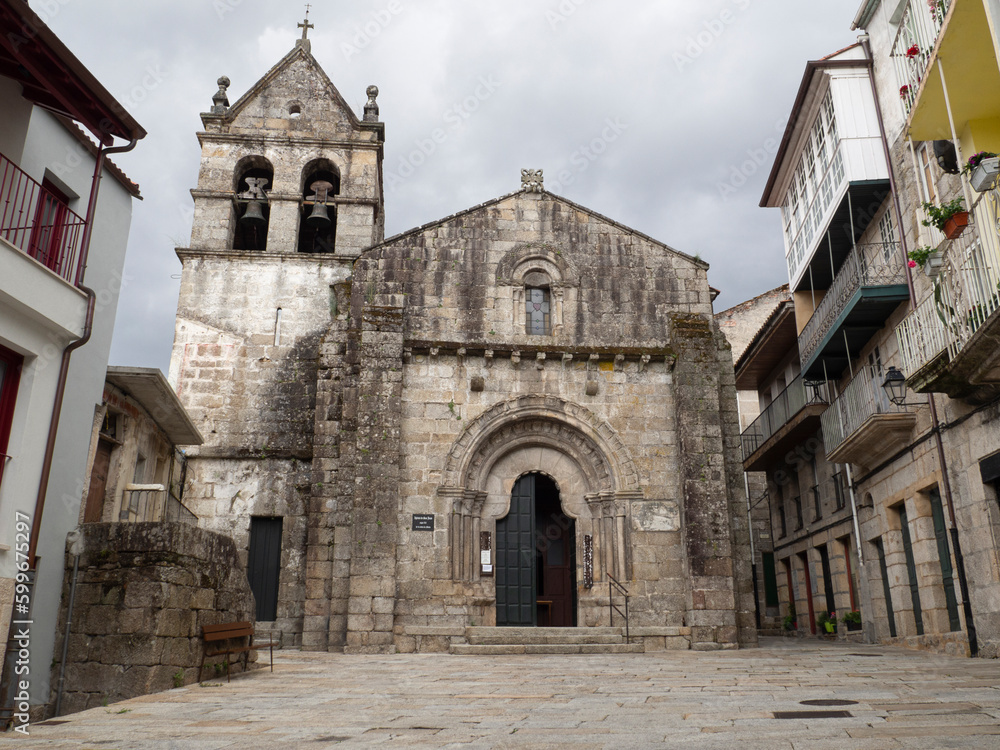 Church of San Juan de Ribadavia, 12th century, in Orense, Spain, summer of 2021, with a green door with semicircular archivolts and a military appearance.