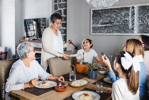 Billede på lærred latin family of multi generational women eating together at home in Mexico Latin