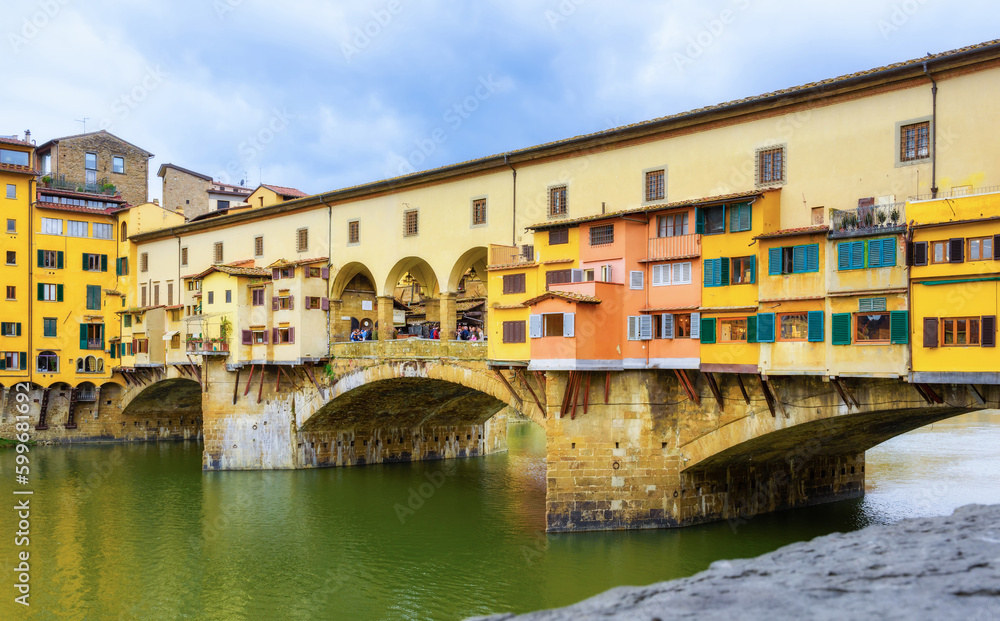 Ponte Vecchio bridge over the river Arno in Florence Italy. Florence is a popular tourist destination of Europe.