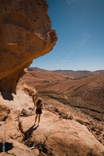 Girl in a desert landscape of the mountains of Fuerteventura in the Canary Islands