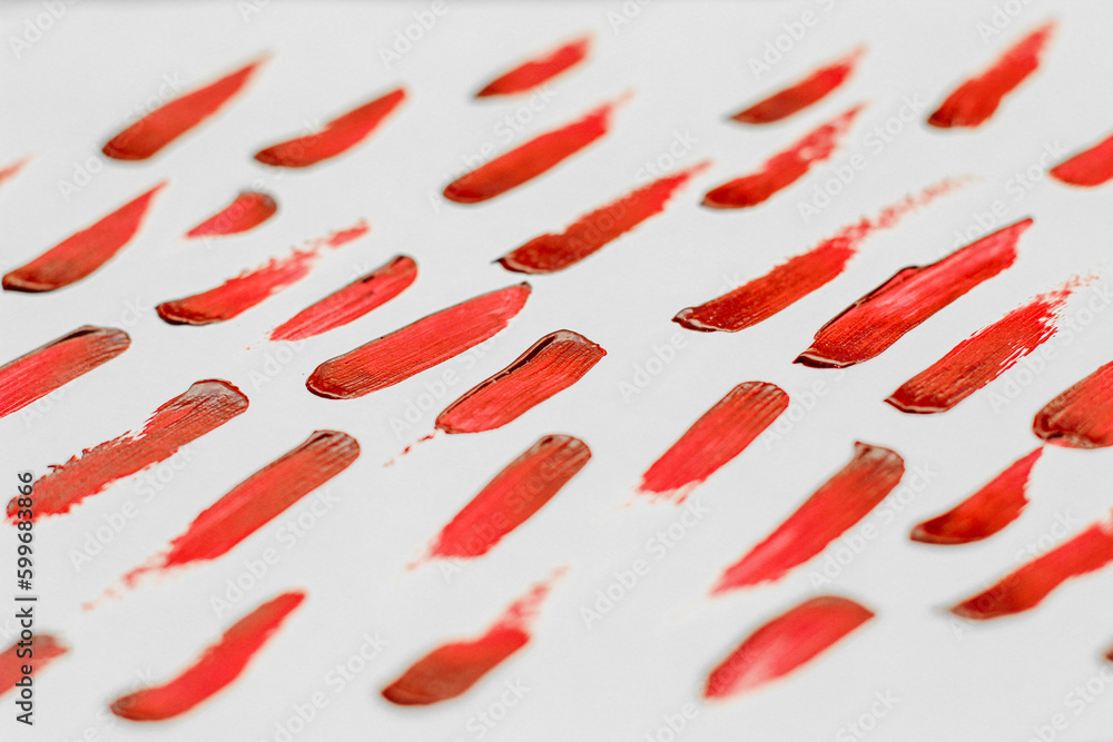 Smears of red cosmetic lipstick on a light background. Smears of red cosmetic lipstick on a light background.
