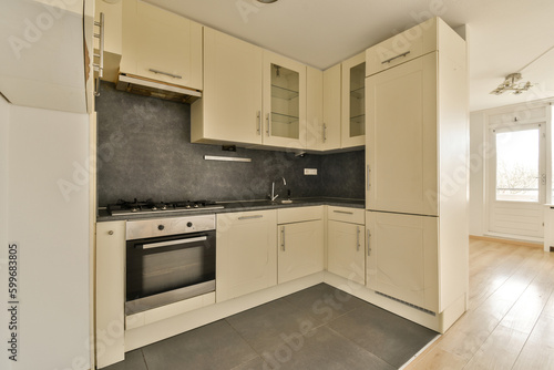 a kitchen with white cupboards and black counter tops on the floor in front of the oven, sink and dishwasher