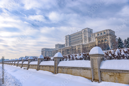 Large building of the Palace of the Parliament also known as People's House (Casa Poporului) in Constitutiei Square (Piata Constitutiei) in Bucharest, Romania, East Europe, in snowy winter scenery photo