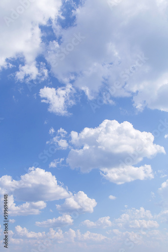 Fototapeta Naklejka Na Ścianę i Meble -  Beautiful epic soft gentle blue sky with white fluffy clouds in sunlight background texture