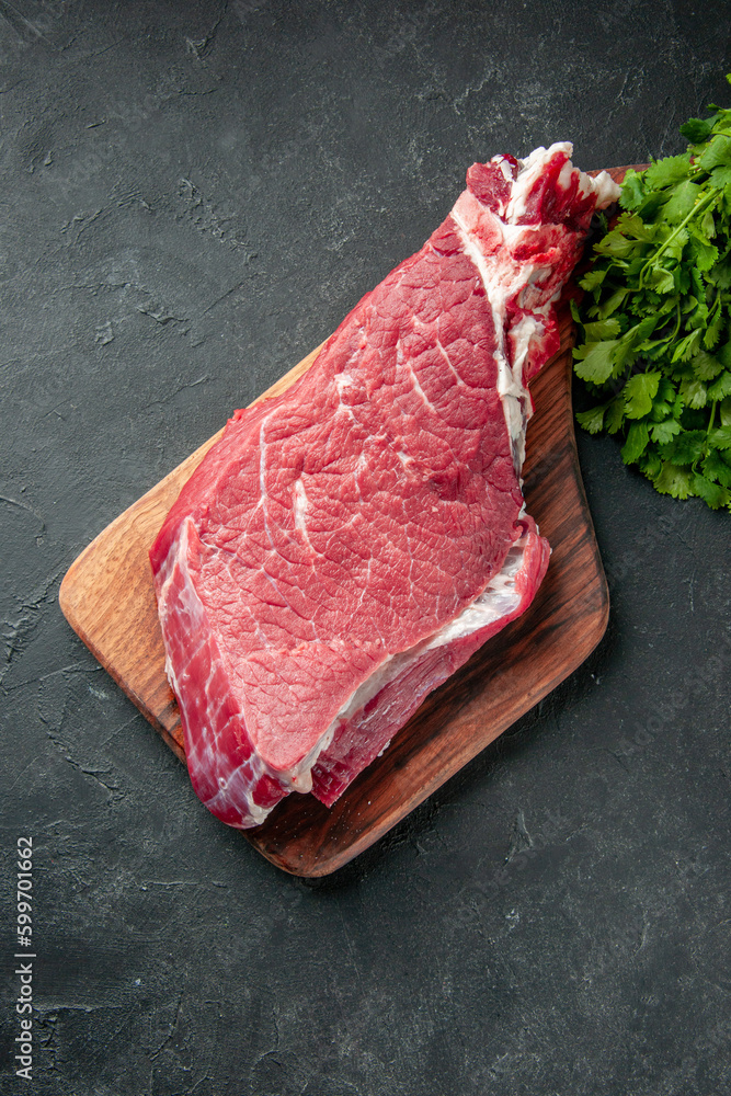 top view raw meat slice with greens on a dark background color food meat barbecue cooking meal butcher