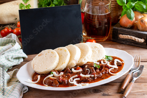 The perfect goulash prepared according to a classic recipe. Traditional Czech Goulash meal with dumplings. Place for text