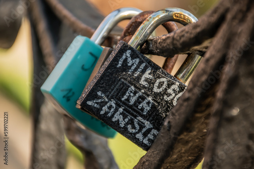 Painted padlock hanging on the bridge