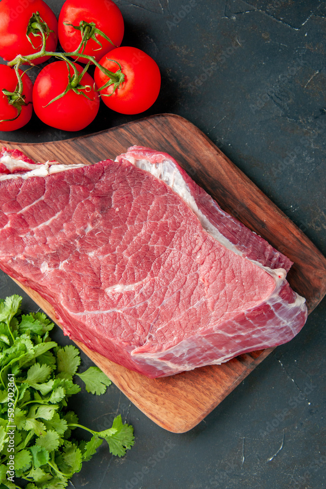 top view raw meat slice with red tomatoes and greens on dark background color butcher meal food food barbecue cooking