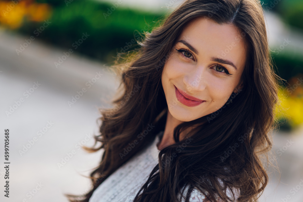 Headshot of a fashionable boho brunette smiling at the camera outdoors. Headshot of a fashionable boho brunette smiling at the camera outdoors.