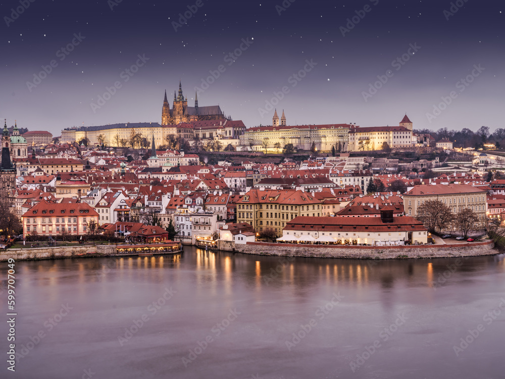 Mala Strana and the catle lit up at night on Vltava river, Prague, Czech Republic