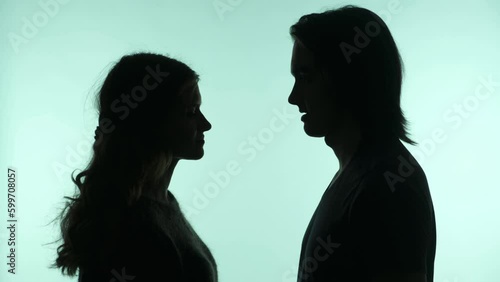Silhouettes of a man shouting at a girl on an isolated background