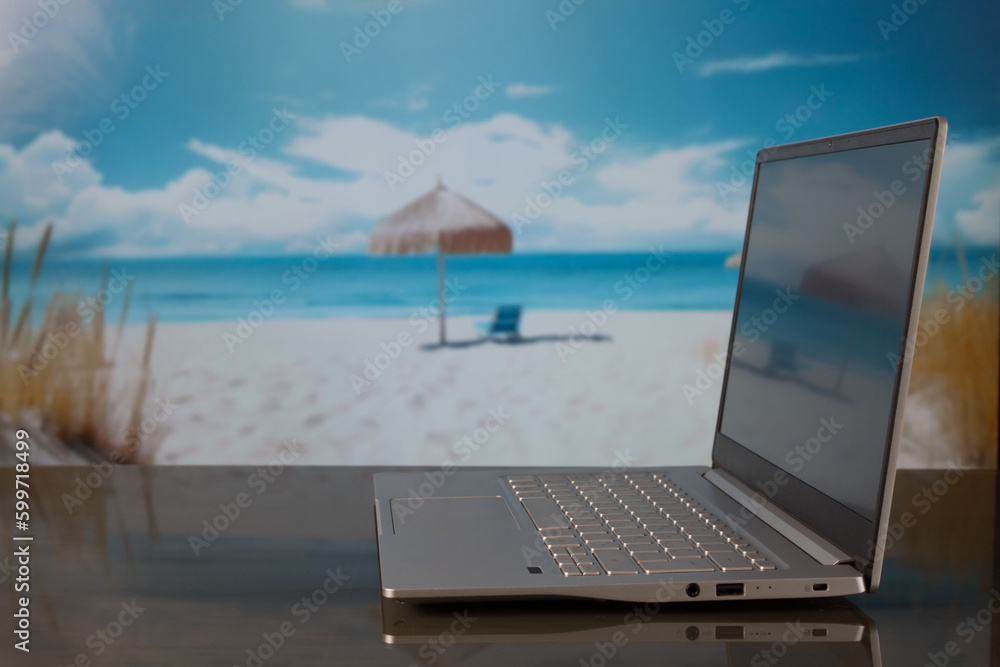 Gray laptop with blurred beach club background Gray laptop with blurred beach club background