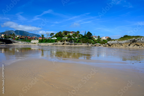 View on Playa de Palombina Las Camaras in Celorio, Green coast of Asturias, North Spain with sandy beaches, cliffs, hidden caves, green fields and mountains.